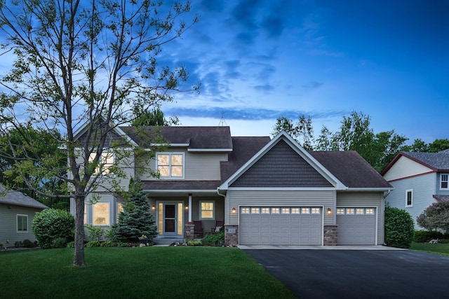 813 Quie Ln, Northfield, MN 55057 - craftsman inspired home featuring a garage, a front lawn, driveway, stone siding, and roof with shingles