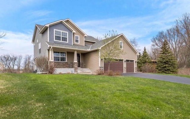 7387 Old Mill Rd, Centerville, MN 55038 - view of front of home featuring stone siding, asphalt driveway, a front lawn, a porch, and a garage