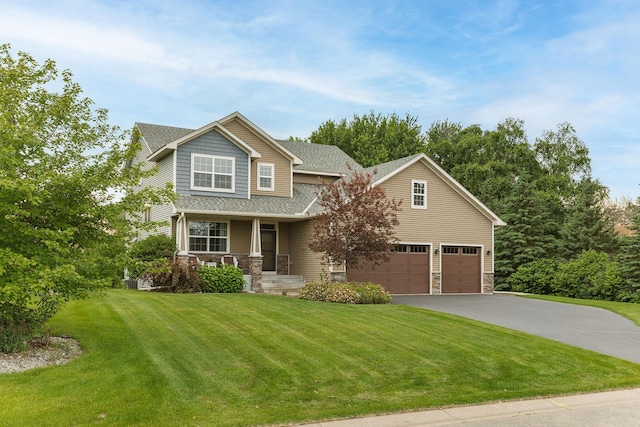 7387 Old Mill Rd, Centerville, MN 55038 - craftsman inspired home with asphalt driveway, a porch, a front lawn, roof with shingles, and stone siding