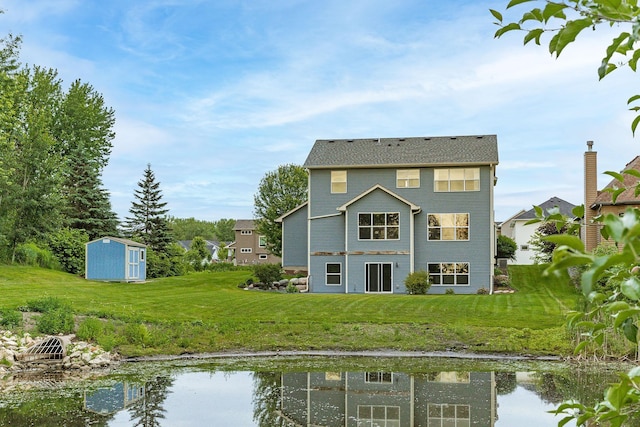 7387 Old Mill Rd, Centerville, MN 55038 - back of property with a storage shed, a lawn, and a water view