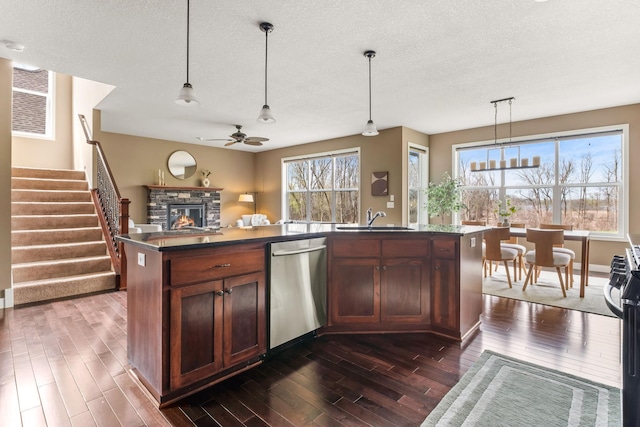 7387 Old Mill Rd, Centerville, MN 55038 - kitchen featuring dishwasher, a stone fireplace, dark wood-style floors, and a textured ceiling