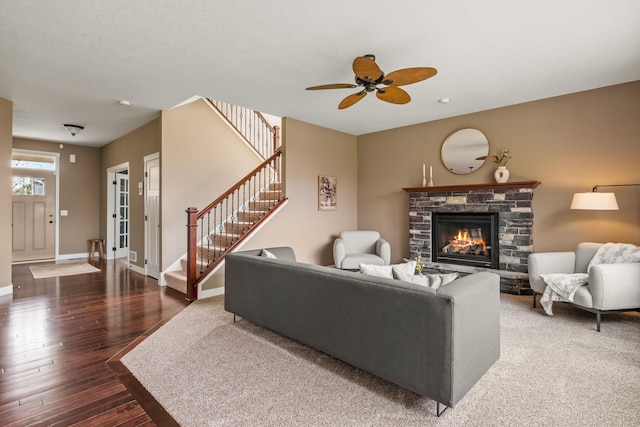 7387 Old Mill Rd, Centerville, MN 55038 - living room with wood-type flooring, stairs, a stone fireplace, and ceiling fan
