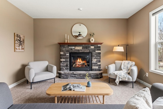 7387 Old Mill Rd, Centerville, MN 55038 - carpeted living area with a stone fireplace and ceiling fan