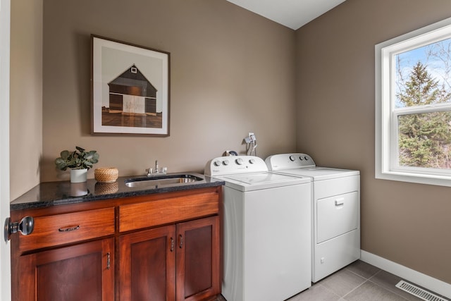 7387 Old Mill Rd, Centerville, MN 55038 - laundry room featuring washing machine and dryer, cabinet space, and light tile patterned floors