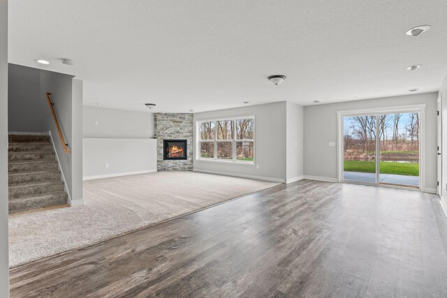 7387 Old Mill Rd, Centerville, MN 55038 - unfurnished living room featuring plenty of natural light, wood finished floors, stairway, and a textured ceiling