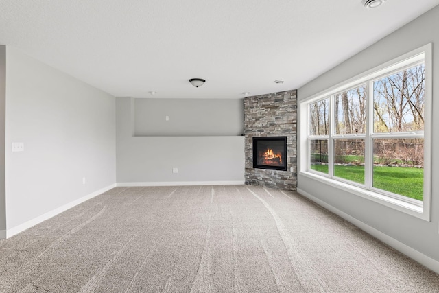 7387 Old Mill Rd, Centerville, MN 55038 - unfurnished living room with healthy amount of natural light, a stone fireplace, and carpet flooring