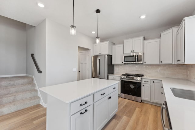 kitchen with backsplash, stainless steel appliances, light wood-type flooring, and light countertops