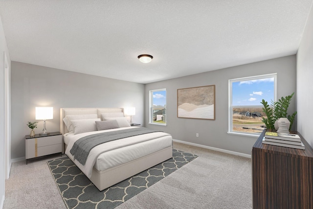 carpeted bedroom featuring a textured ceiling and baseboards