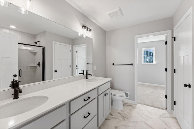 bathroom with double vanity, a sink, marble finish floor, and a stall shower