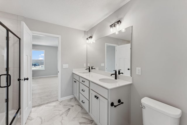 full bath featuring a sink, a shower stall, double vanity, and marble finish floor