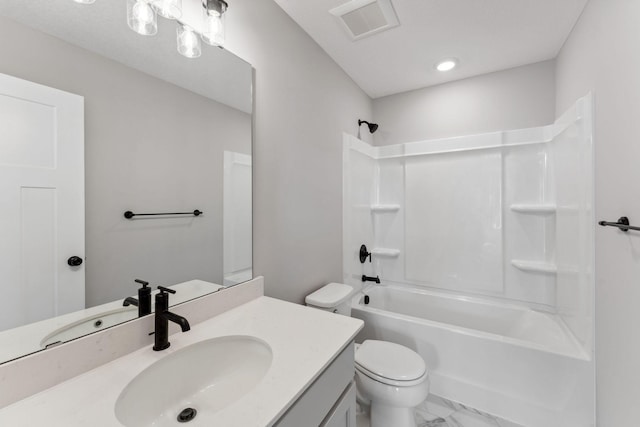 bathroom featuring visible vents, vanity, marble finish floor, toilet, and shower / washtub combination