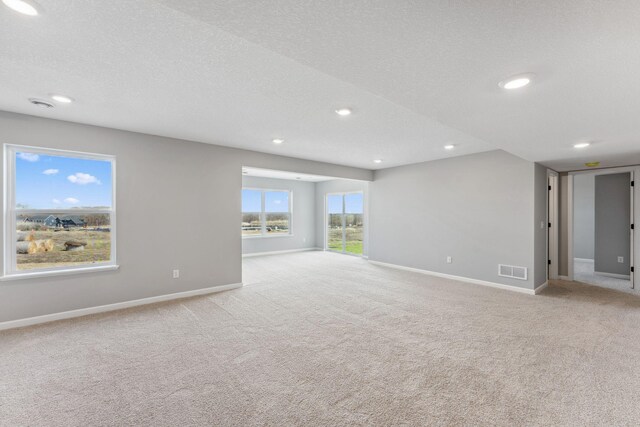 unfurnished room with visible vents, recessed lighting, baseboards, and carpet floors