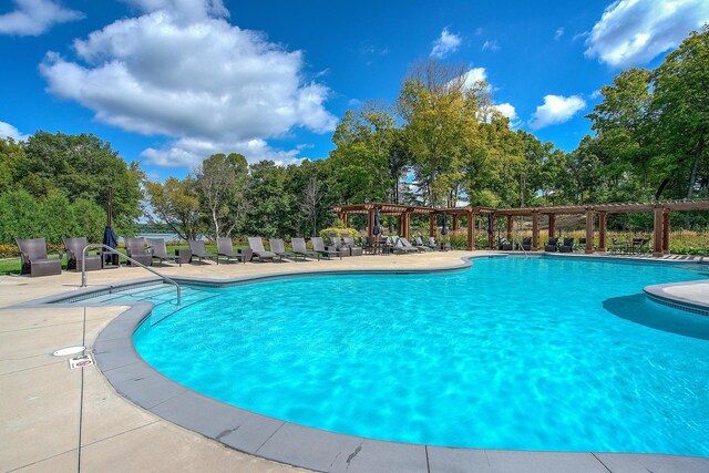 pool with a patio and a pergola