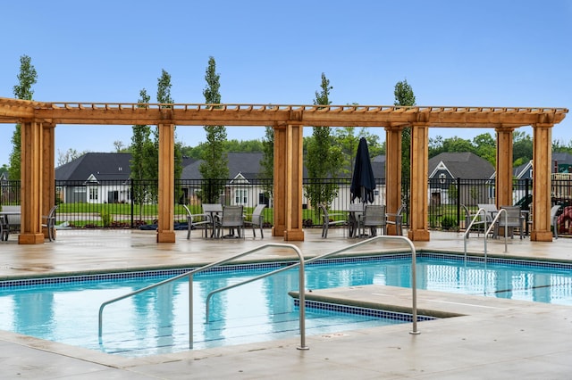 community pool featuring fence and a patio