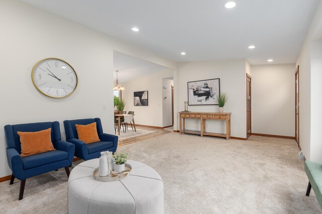 1715 107th St, New Richmond, WI 54017 - living area featuring lofted ceiling, recessed lighting, light colored carpet, baseboards, and a chandelier