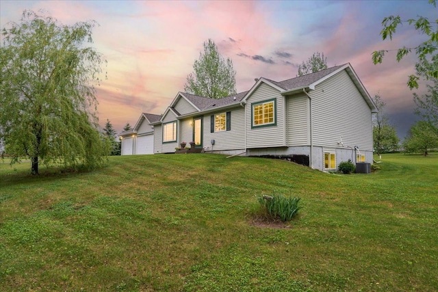 1715 107th St, New Richmond, WI 54017 - view of front of home with a lawn, central AC, and a garage