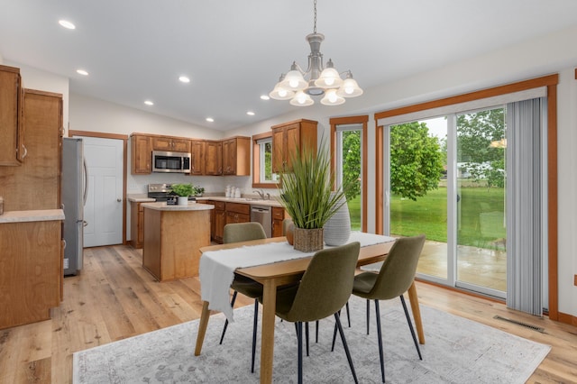 1715 107th St, New Richmond, WI 54017 - dining room with a chandelier, lofted ceiling, recessed lighting, and light wood-style flooring