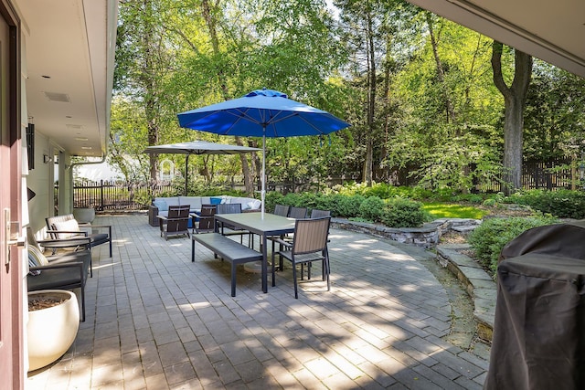 4721 Lake Harriet Pkwy, Minneapolis, MN 55419 - fenced backyard featuring outdoor dining area, a patio area, an outdoor hangout area, grilling area, and view of scattered trees
