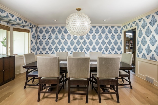 4721 Lake Harriet Pkwy, Minneapolis, MN 55419 - dining room with wallpapered walls, crown molding, light wood-style floors, and wainscoting