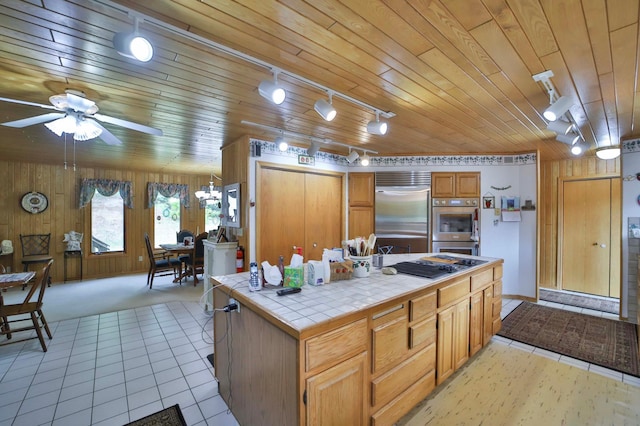 7717 Lake May Rd NW, Walker, MN 56433 - kitchen with tile counters, appliances with stainless steel finishes, track lighting, a ceiling fan, and wood ceiling