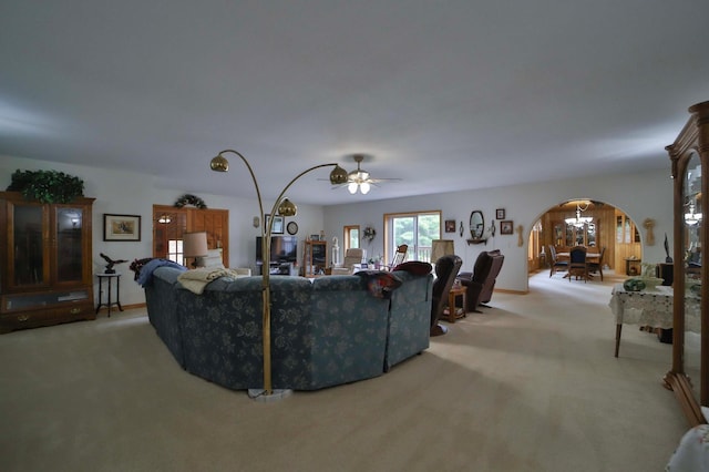 7717 Lake May Rd NW, Walker, MN 56433 - living area with arched walkways, light carpet, and a ceiling fan