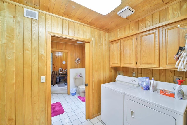 7717 Lake May Rd NW, Walker, MN 56433 - laundry area featuring cabinet space, washing machine and clothes dryer, wooden walls, light tile patterned flooring, and wooden ceiling