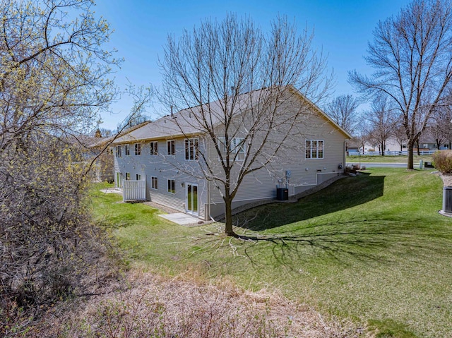 view of home's exterior with central AC unit and a yard