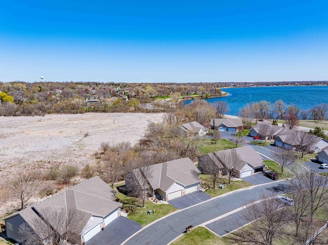 birds eye view of property with a water view and a residential view