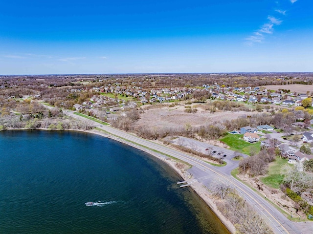 drone / aerial view featuring a residential view and a water view