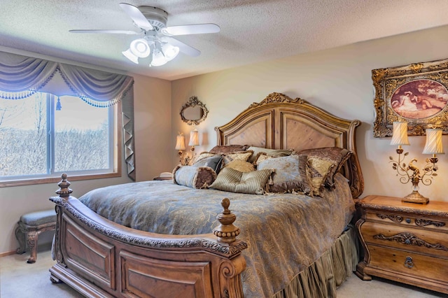 bedroom with a ceiling fan, a textured ceiling, and light colored carpet