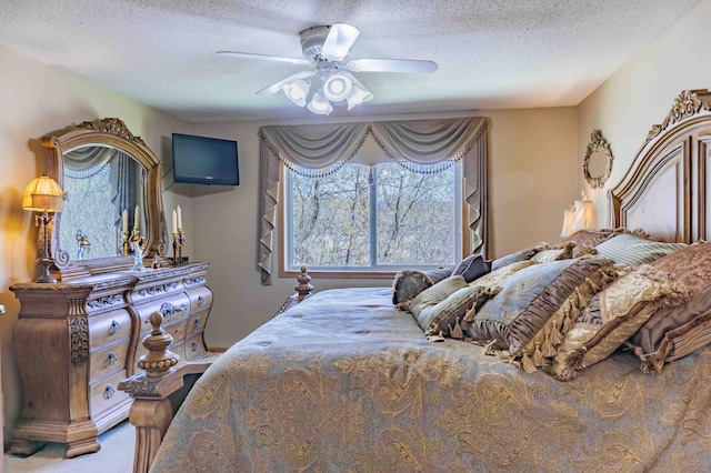 bedroom featuring carpet floors, a textured ceiling, and ceiling fan