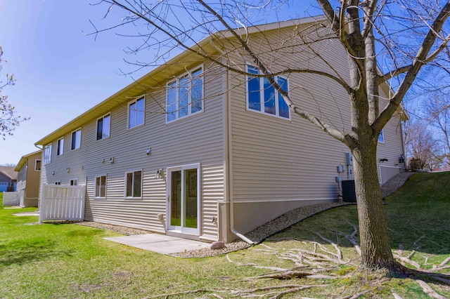 back of house featuring a patio area and a yard