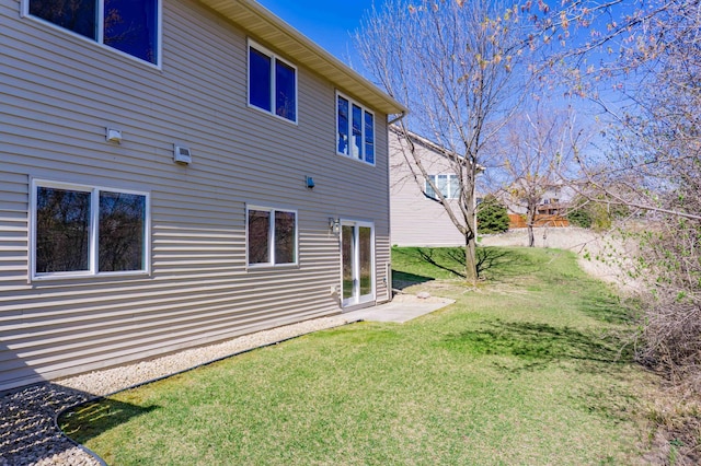 back of property with a lawn