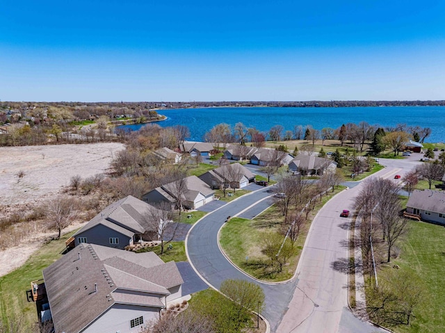 drone / aerial view with a residential view and a water view