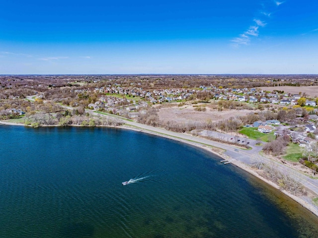 drone / aerial view featuring a water view and a residential view