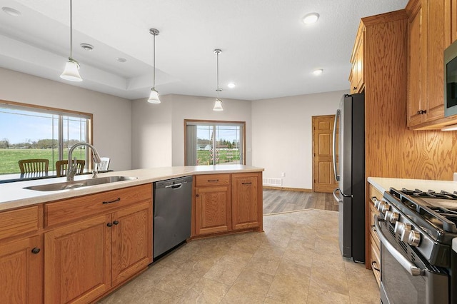 kitchen with light countertops, stainless steel appliances, visible vents, and a sink