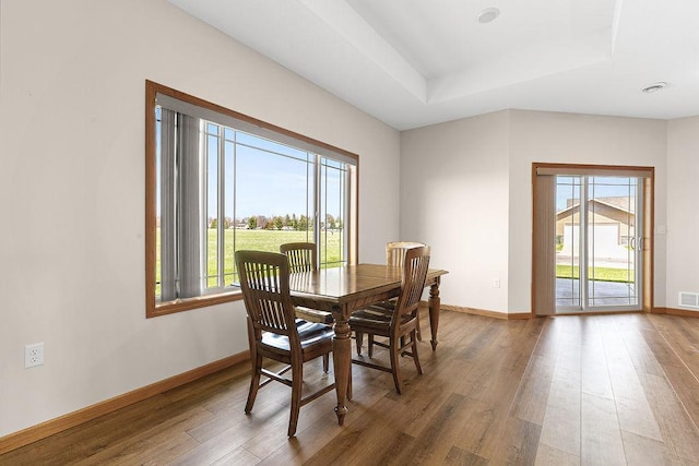 dining space featuring plenty of natural light, wood finished floors, and visible vents