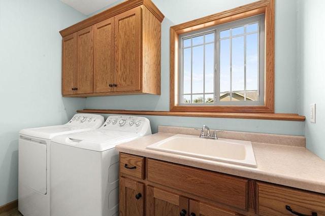 laundry room featuring a sink, cabinet space, and washer and clothes dryer