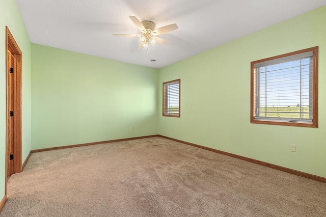 unfurnished bedroom with baseboards, carpet flooring, and a ceiling fan
