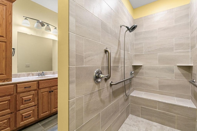 full bath with vanity and tiled shower