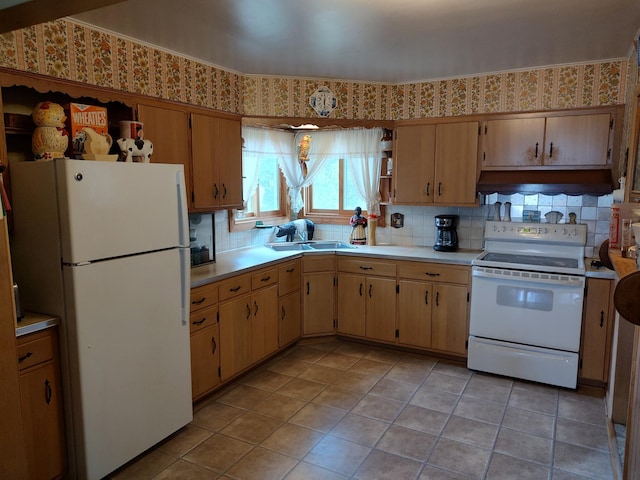 kitchen with light tile patterned floors, decorative backsplash, light countertops, under cabinet range hood, and white appliances