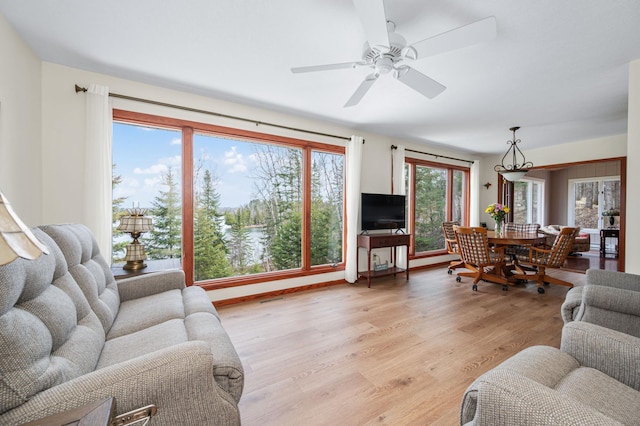 living room featuring light wood finished floors and ceiling fan