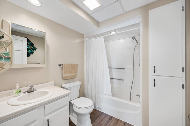 full bathroom with vanity, toilet, wood finished floors, and shower / bath combo