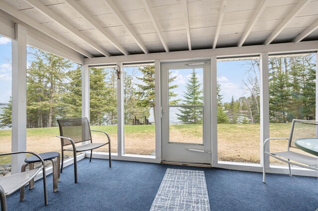 sunroom featuring a wealth of natural light and beam ceiling