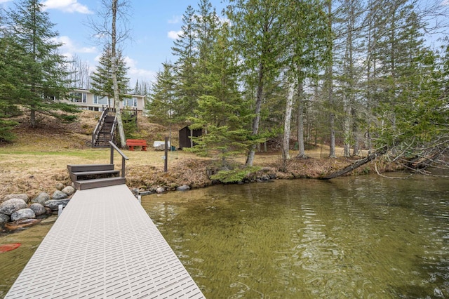 dock area featuring stairs and a water view