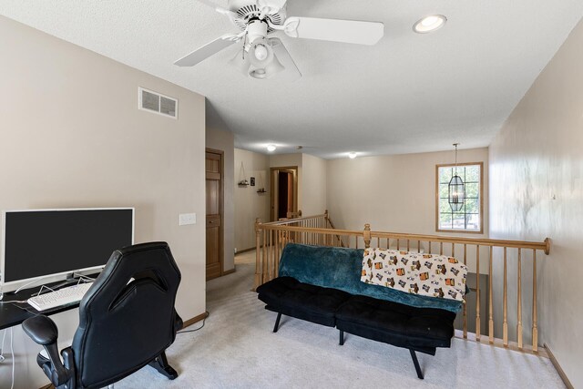 office with light colored carpet and a ceiling fan