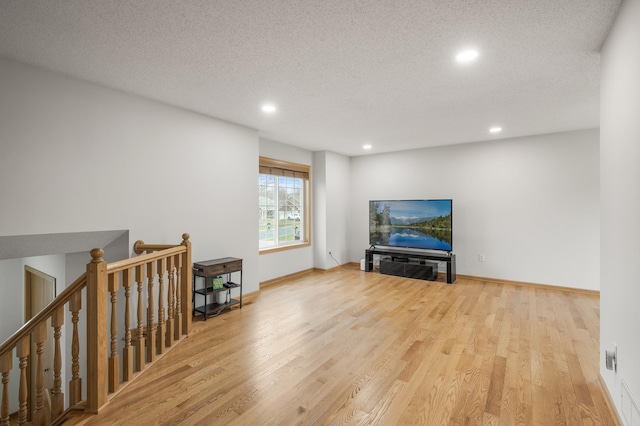 664 Highland Trl, Lino Lakes, MN 55014 - living area with recessed lighting, wood finished floors, an upstairs landing, and a textured ceiling