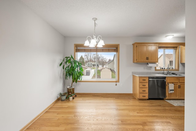 664 Highland Trl, Lino Lakes, MN 55014 - kitchen featuring dishwashing machine, a chandelier, light countertops, pendant lighting, and light wood-style flooring