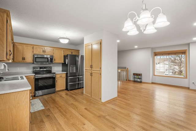 664 Highland Trl, Lino Lakes, MN 55014 - kitchen featuring stainless steel appliances, light wood-style flooring, light countertops, a chandelier, and recessed lighting