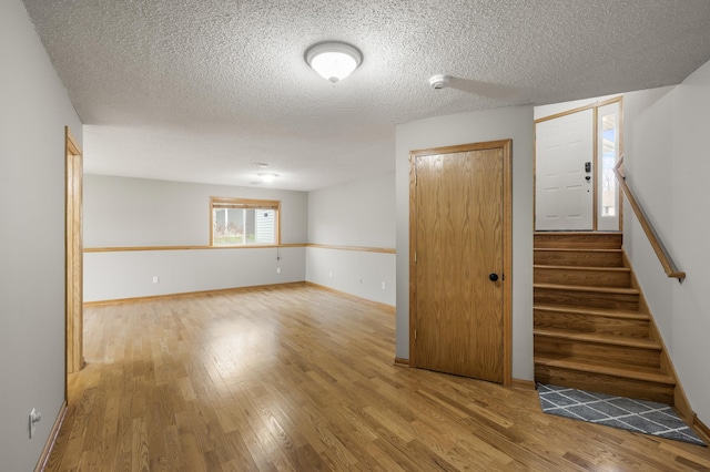 664 Highland Trl, Lino Lakes, MN 55014 - unfurnished room featuring wood finished floors, a smoke detector, stairs, and a textured ceiling
